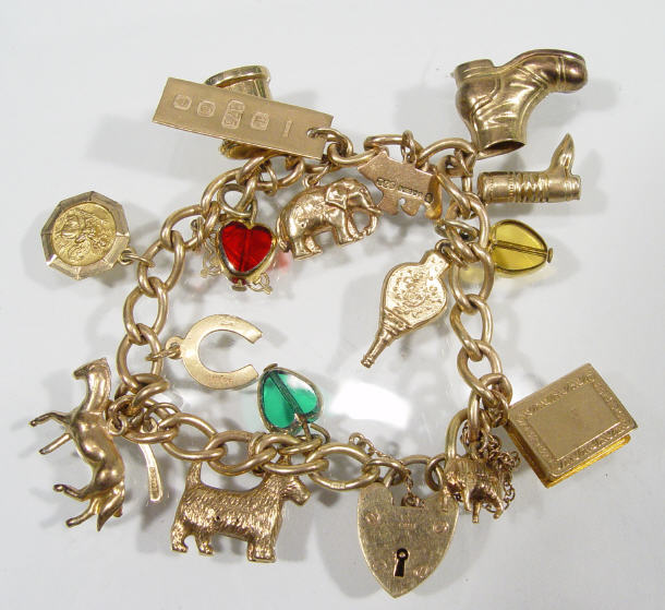 Appraisal: ct gold charm bracelet with assorted charms including boots dogs