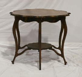 Appraisal: A stained maple center table with shaped top and six