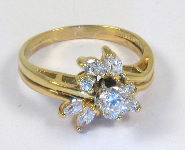 Appraisal: DIAMOND AND EIGHTEEN KARAT GOLD RING centering a round brilliant-cut