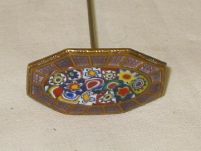 Appraisal: A MILLIFIORE ENAMEL HAT PIN of faceted oval form with