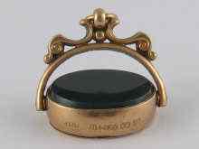 Appraisal: A hallmarked carat gold bloodstone set swivel seal with locket