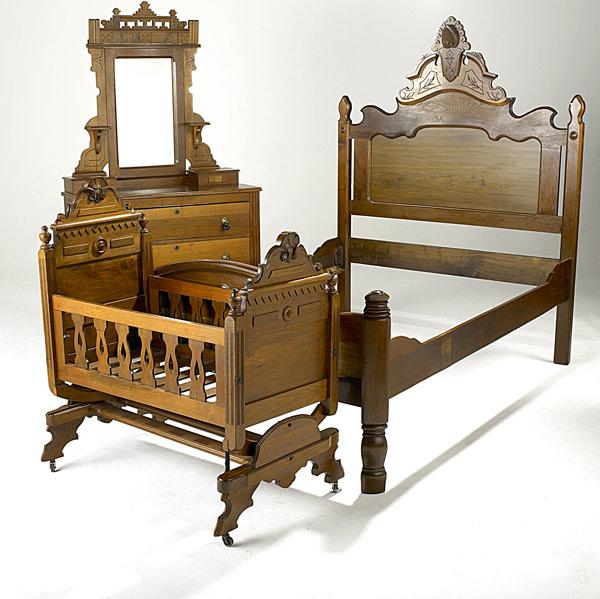 Appraisal: VICTORIAN FURNITURE ENSEMBLE Walnut ca Mirrored dresser cradle and high-backed