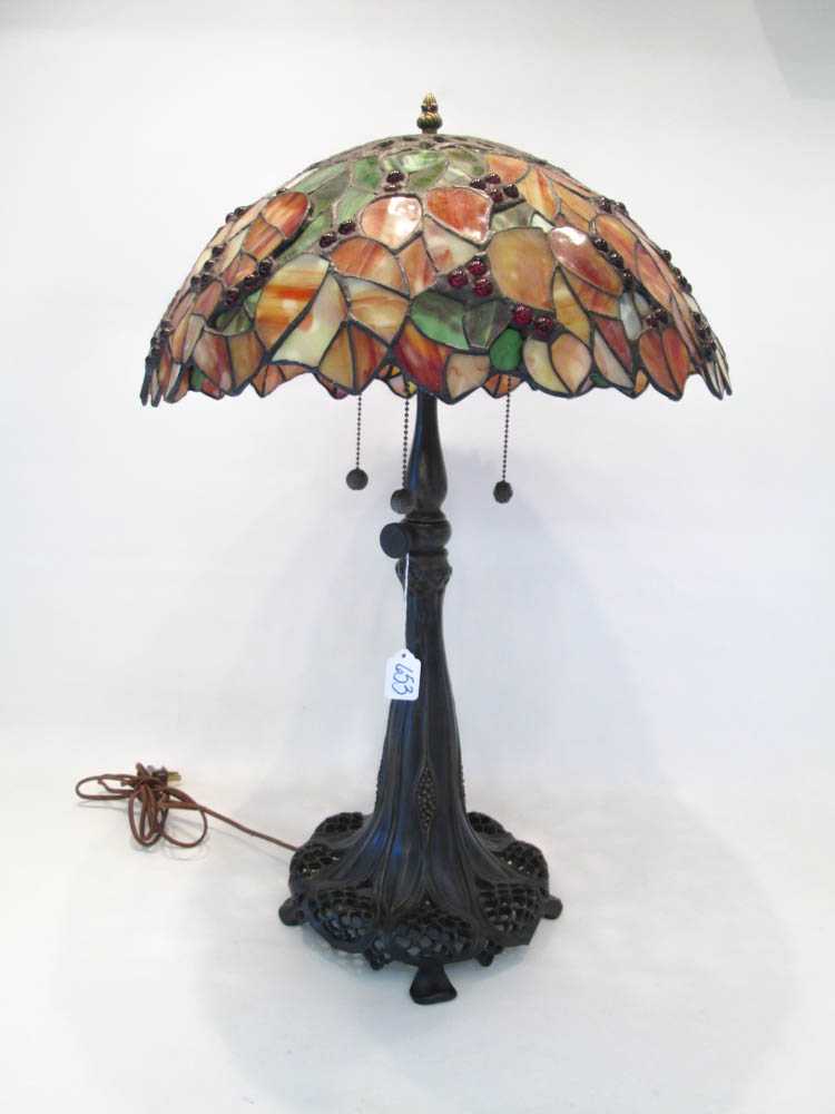 Appraisal: A TIFFANY STYLE TABLE LAMP stained and leaded glass domed