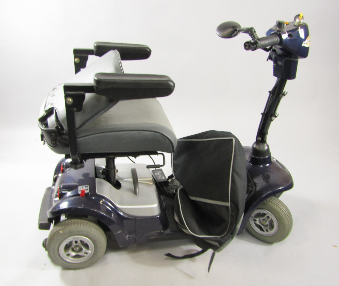 Appraisal: A Strider mobility scooter with battery charging cable and basket