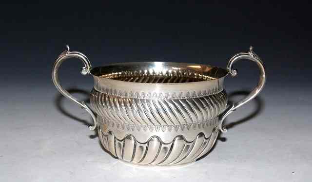 Appraisal: A VICTORIAN SILVER QUEEN ANNE STYLE PORRINGER with wrythen fluted