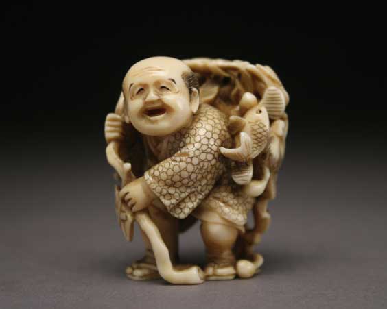 Appraisal: CARVED IVORY NETSUKE Large finely carved and openwork ivory netsuke