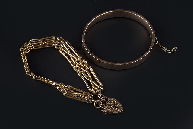 Appraisal: TWO BRACELETS the first a fancy gate-link bracelet with padlock