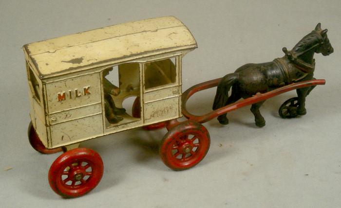 Appraisal: Cast iron toy horse drawn milk cart with removable driver