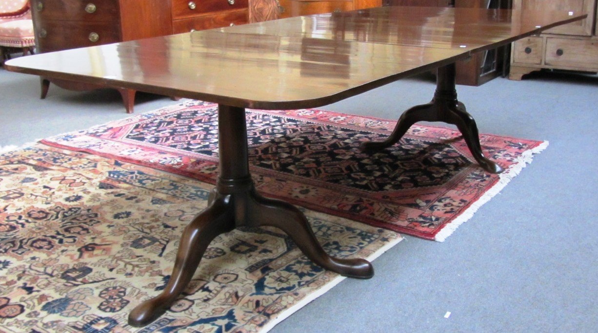 Appraisal: A mid th century style mahogany extending dining table on