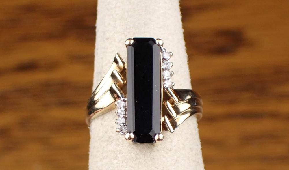 Appraisal: DIAMOND AND BLACK ONYX RING K yellow gold long narrow