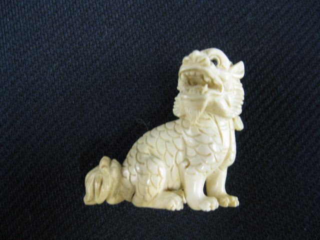 Appraisal: Carved Ivory Netsuke of a Seated Foo Dog onyx eyes