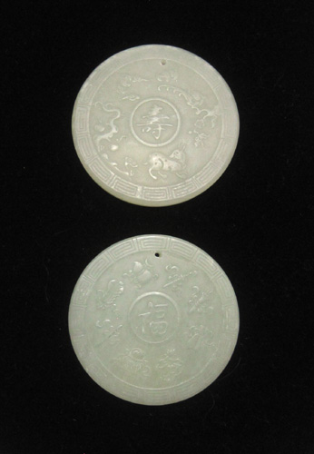 Appraisal: TWO CHINESE LIGHT GREEN JADE AMULETS each round carved jade