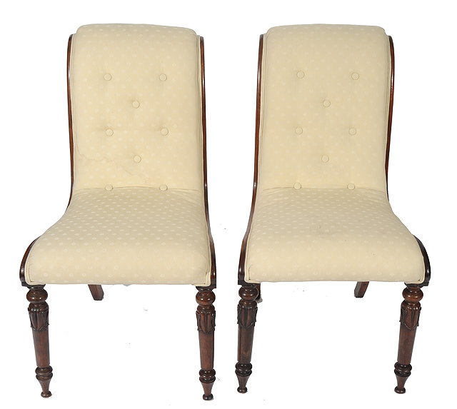 Appraisal: A PAIR OF ROSEWOOD AND CREAM UPHOLSTERED SLIPPER CHAIRS with