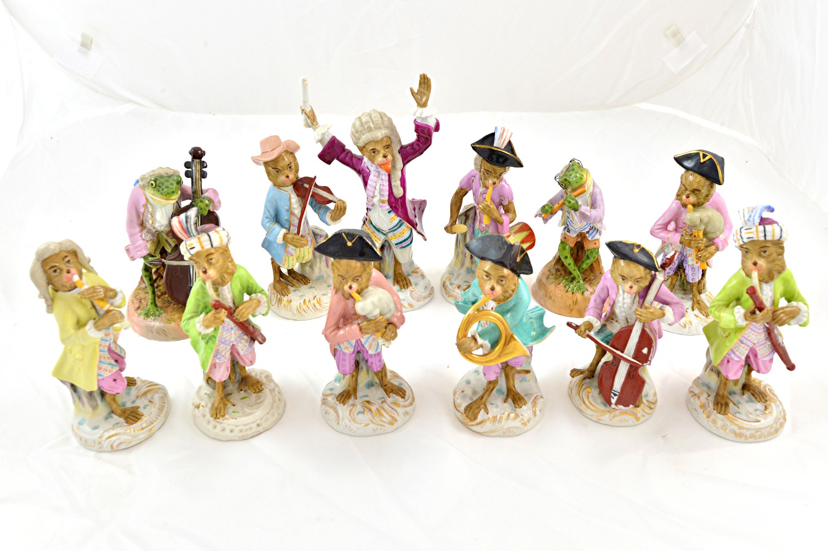 Appraisal: Ten Volkstadt porcelain monkey band musicians including the conductor varying