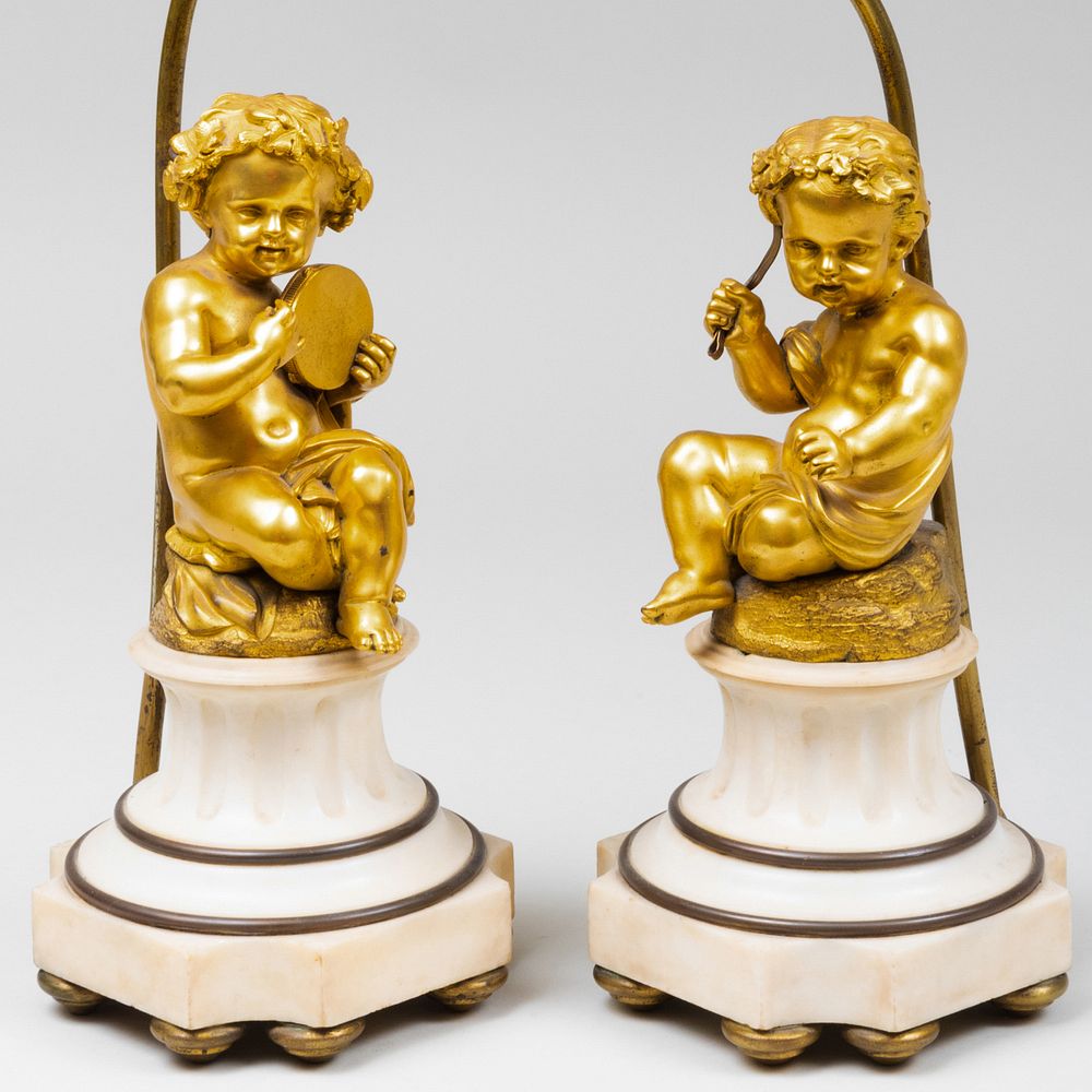 Appraisal: Pair of Gilt Bronze and Marble Figural Putti Lamps x