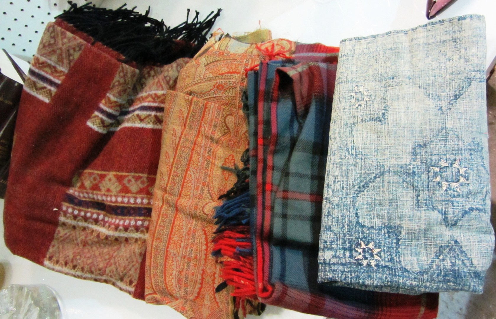 Appraisal: A Paisley shawl an indigo panel a wool plaid shawl