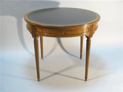 Appraisal: BAKER WALNUT AND LEATHER CENTER TABLE The circular tooled leather