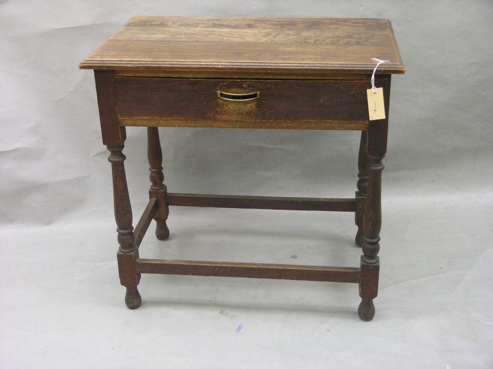 Appraisal: A solid dark oak side table with single drawer on