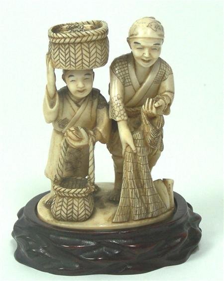 Appraisal: A Japanese ivory okimono of two fisherman Meiji period Signed