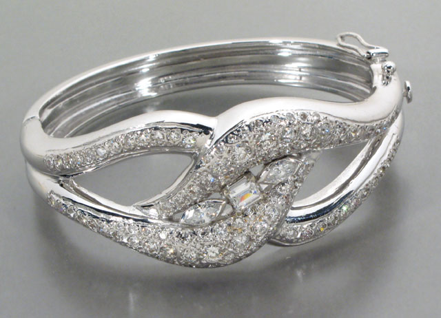 Appraisal: DIAMOND AND FOURTEEN KARAT WHITE GOLD BANGLE WITH APPRAISAL The