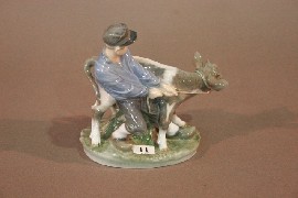 Appraisal: A Royal Copenhagen figure of a boy with a cow