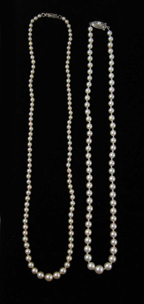 Appraisal: TWO STRANDS OF GRADUATED WHITE PEARL NECKLACES including a matinee