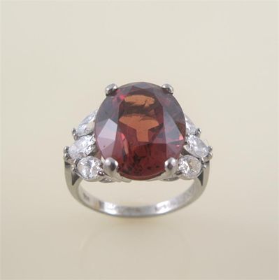 Appraisal: A garnet and diamond ring the oval shaped garnet is