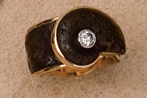 Appraisal: DIAMOND AND FOSSIL RING k yellow gold ring with ammonite