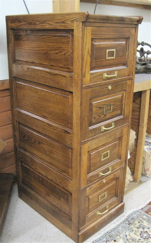 Appraisal: FOUR-DRAWER OAK FILE CABINET American antique reproduction featuring a column