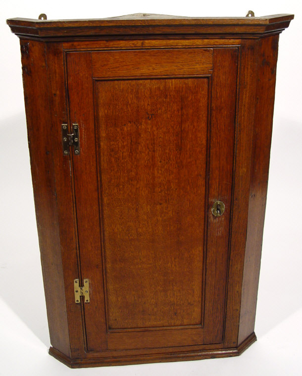 Appraisal: th Century oak hanging corner cabinet the panel door enclosing