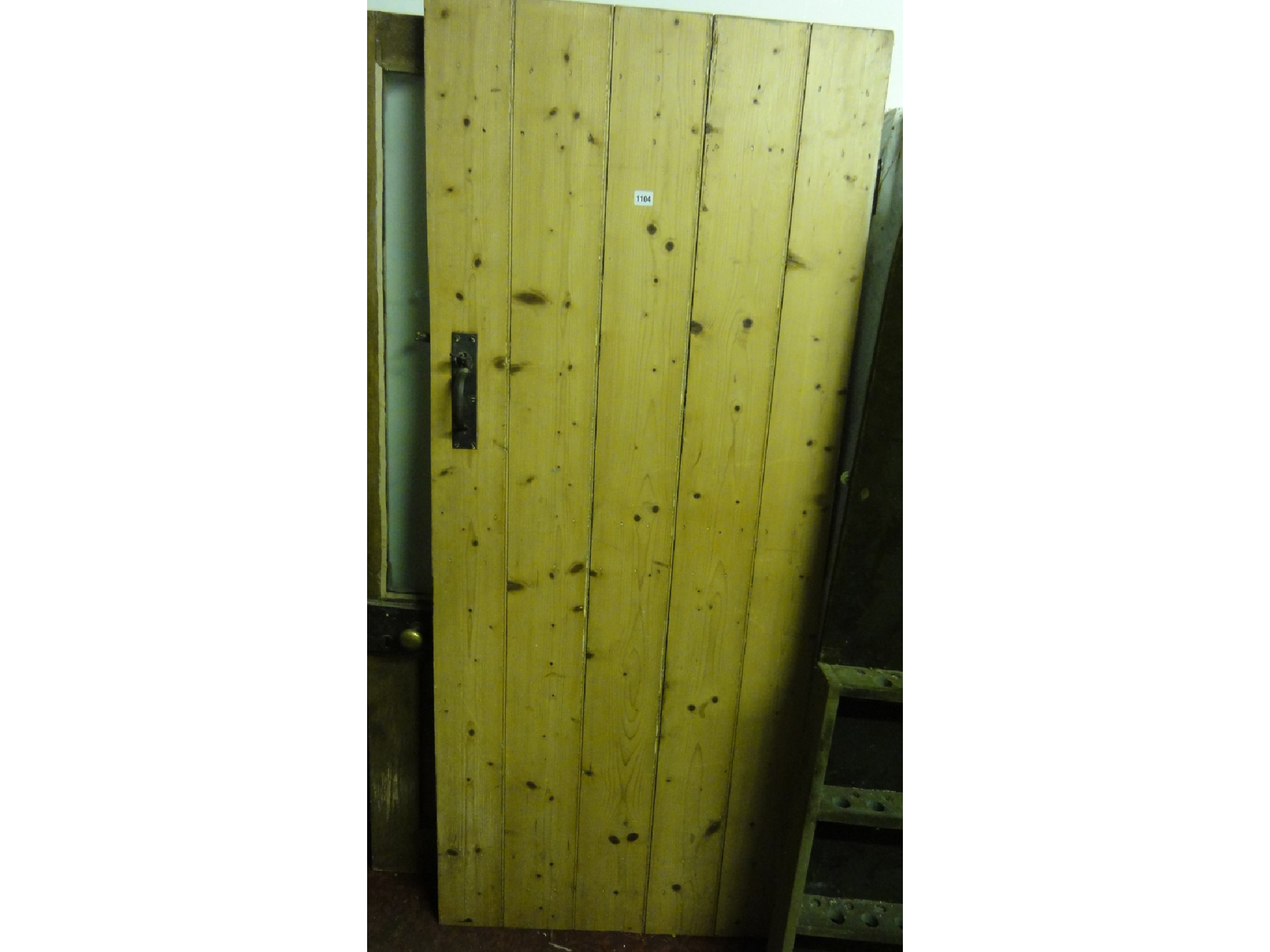 Appraisal: A reclaimed stripped pine ledge and braced internal door with