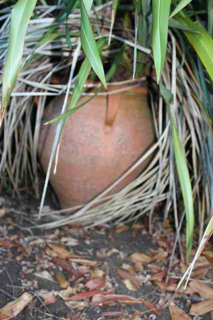 Appraisal: A TERRACOTTA PLANTER of ovoid form with ribbed decoration high