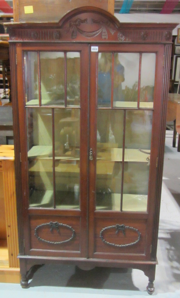 Appraisal: A th century walnut glazed display cabinet