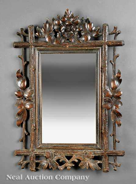 Appraisal: An Antique Black Forest Carved Walnut Mirror c beveled mirror