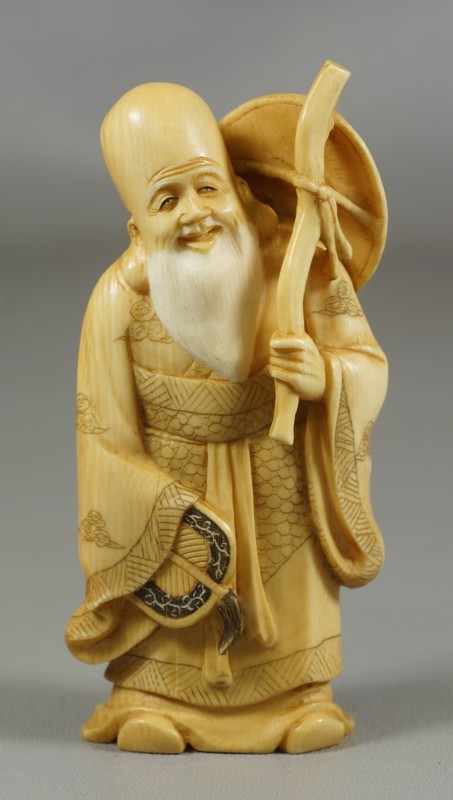 Appraisal: Carved ivory figure of a bearded man carrying a fan