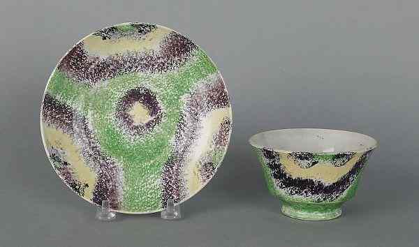 Appraisal: Purple green yellow and black rainbow spatter cup and saucer