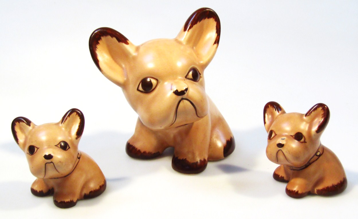 Appraisal: A graduated set of three Sylvac style pottery dogs brown