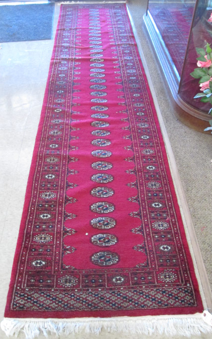 Appraisal: HAND KNOTTED BOKHARA RUNNER Indo-Bokhara red field ' x '