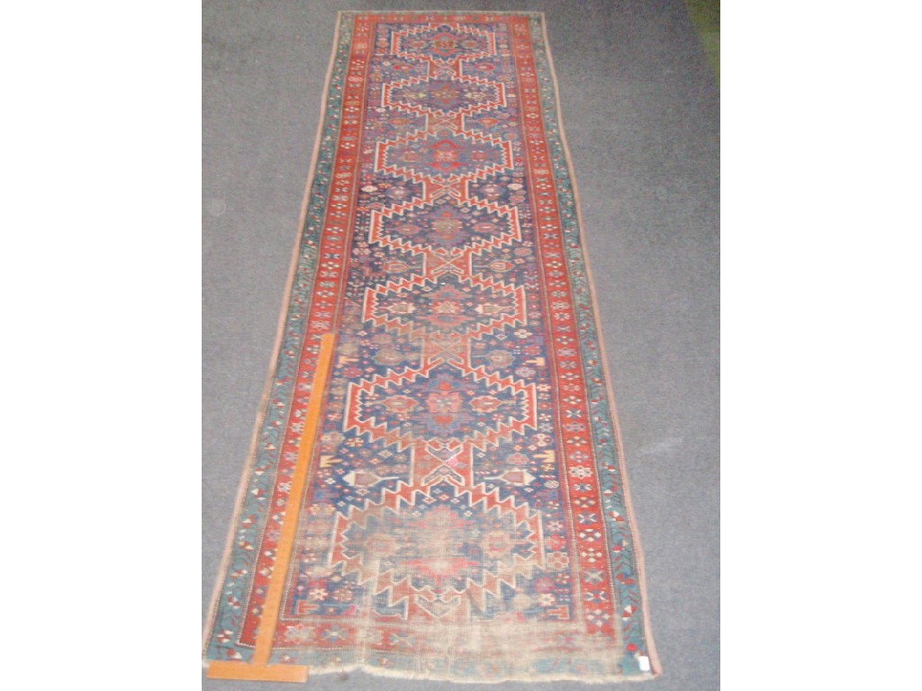 Appraisal: A Karajan Persian runner with seven medallions on a blue