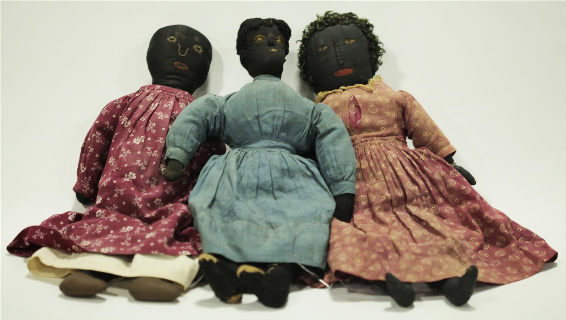 Appraisal: THREE EARLY BLACK CLOTH RAG DOLLS American th century Stitched