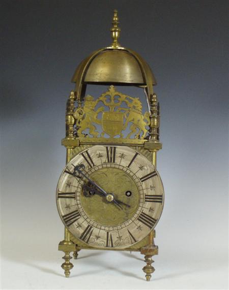 Appraisal: A brass cased lantern clock the silvered chapter ring with