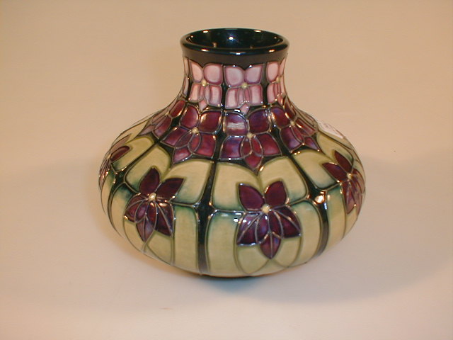 Appraisal: A modern Moorcroft squat vase with stylised pansy decoration