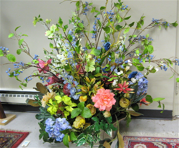 Appraisal: LARGE SILK FLOWER ARRANGEMENT CENTERPIECE the silvered pottery planter containing