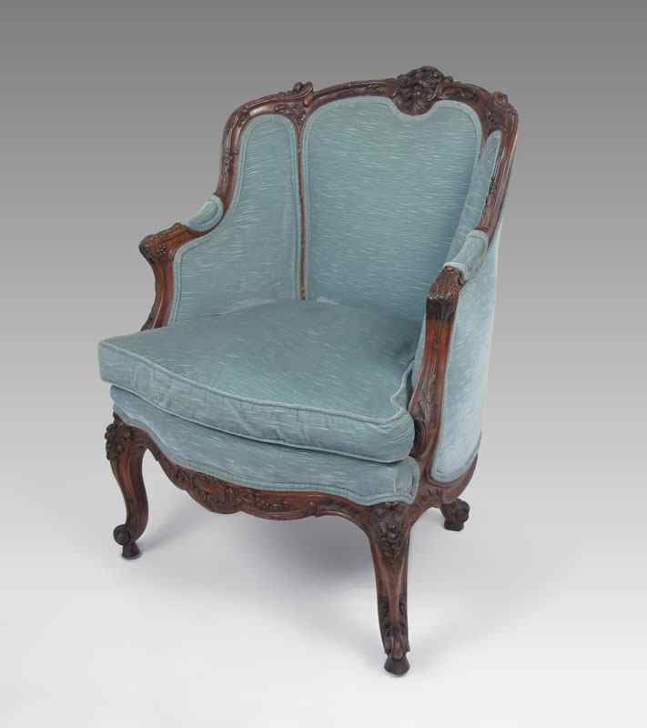 Appraisal: FRENCH CARVED BERGERE CHAIR Profusely carved with blue upholstery and