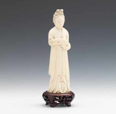 Appraisal: A Carved Ivory Figure of a Lady Depicted standing wearing