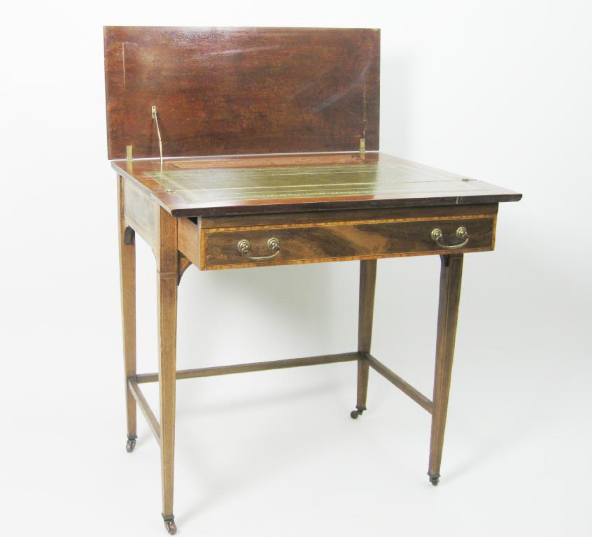 Appraisal: An Edwardian mahogany Writing Table with folding top opening to