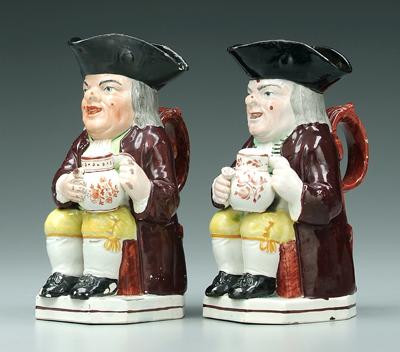 Appraisal: Two similar pearlware Toby jugs seated brown figures with yellow