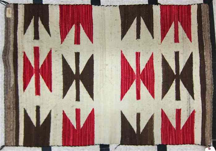 Appraisal: NAVAJO SADDLE BLANKET hand woven in a brown and red