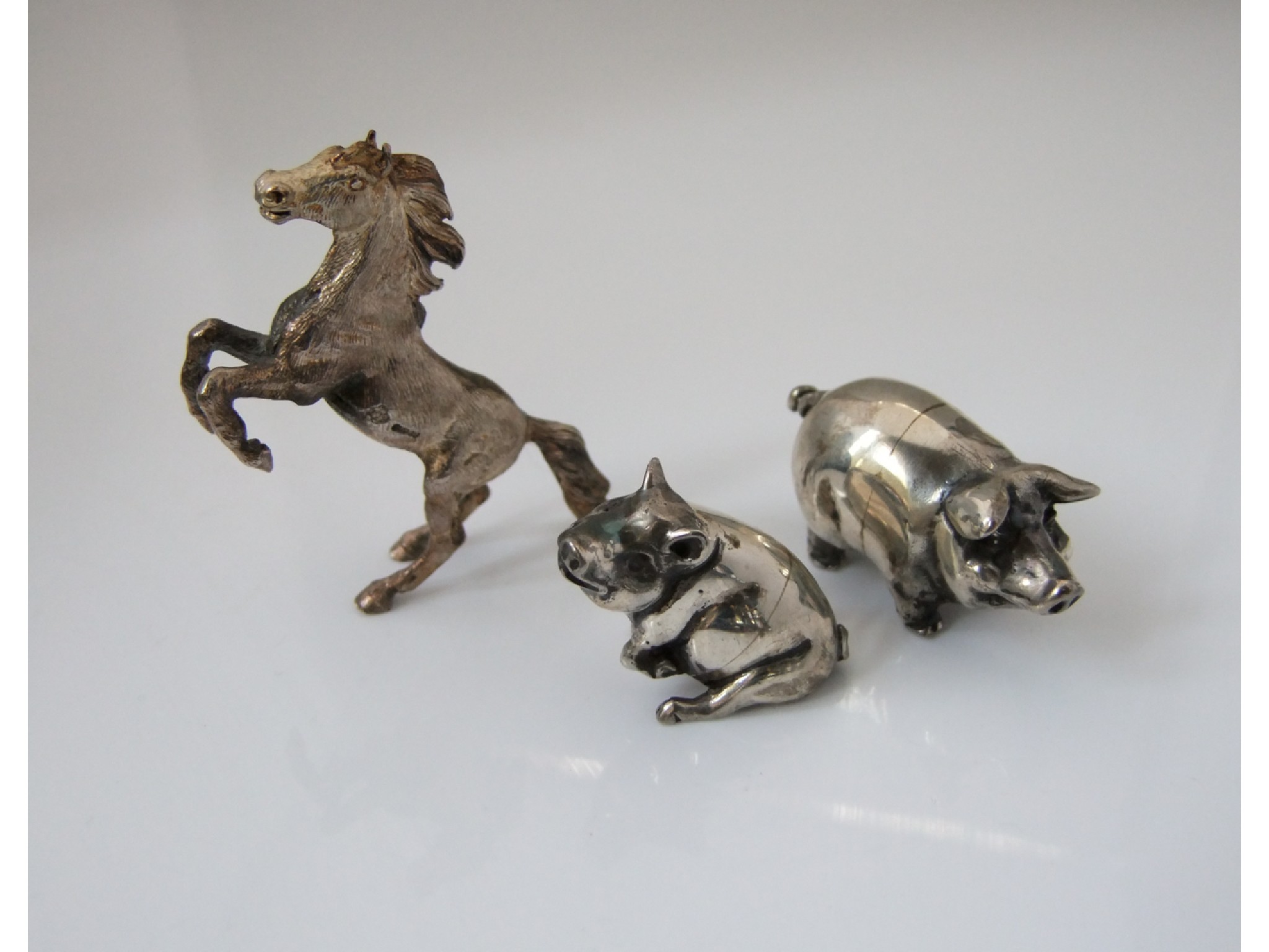 Appraisal: A pair of silver miniature pig figures Practical Silverware London