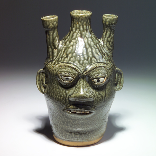 Appraisal: A G MEADERS Stoneware three-opening face jug with seven teeth